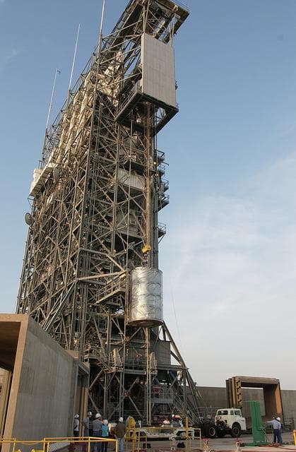 NASA image: KENNEDY SPACE CENTER, FLA. - On Launch Complex 17-B, Cape Canaveral Air Force Station, the Space Infrared Telescope Facility (SIRTF) observatory is lowered to the ground and taken back to NASA Spacecraft Hangar AE. SIRTF will remain in the clean room at Hangar AE until it returns to the pad in early August.
