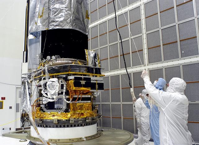 NASA image: KENNEDY SPACE CENTER, FLA. -  Workers in NASA Spacecraft Hangar AE lift the protective cover from around the Space Infrared Telescope Facility (SIRTF), which has been returned to the hangar from the launch pad.   SIRTF will remain in the clean room until it returns to the pad in early August. One of NASA's largest infrared telescopes to be launched, SIRTF will obtain images and spectra by detecting the infrared energy, or heat, radiated by objects in space.