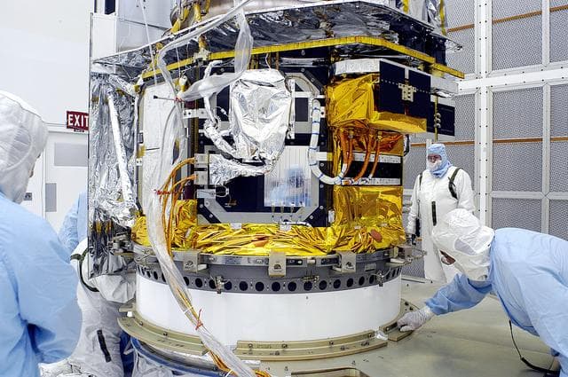 NASA image: KENNEDY SPACE CENTER, FLA. -  In the NASA Spacecraft Hangar AE, the Space Infrared Telescope Facility (SIRTF), which has been returned to the hangar from the launch pad, is uncovered by workers following its arrival.   SIRTF will remain in the clean room until it returns to the pad in early August. One of NASA's largest infrared telescopes to be launched, SIRTF will obtain images and spectra by detecting the infrared energy, or heat, radiated by objects in space.