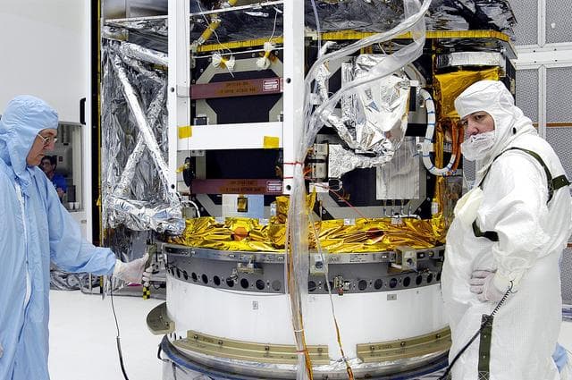 NASA image: KENNEDY SPACE CENTER, FLA. -  Workers in NASA Spacecraft Hangar AE begin the next phase of processing of the Space Infrared Telescope Facility (SIRTF), which has been returned to the hangar from the launch pad. SIRTF will remain in the clean room until it returns to the pad in early August. One of NASA's largest infrared telescopes to be launched, SIRTF will obtain images and spectra by detecting the infrared energy, or heat, radiated by objects in space.