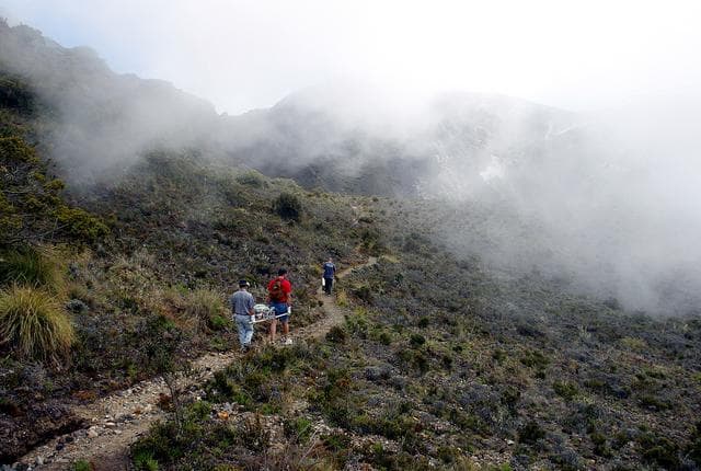 NASA image: KENNEDY SPACE CENTER, FLA. -  Arturo Ramierez, Charles Curley and Duke Follistein, KSC and Costa Rican researchers, carry the hazardous gas detection system AVEMS to the central of the Turrialba volcano.  The Aircraft-based Volcanic Emission Mass Spectrometer determines the presence and concentration of various chemicals.  It is being tested in flights over the Turrialba volcano and in the crater, sampling and analyzing fresh volcanic gases in their natural chemical state.  The AVEMS system has been developed for use in the Space Shuttle program, to detect toxic gas leaks and emissions in the Shuttle’s aft compartment and the crew compartment.