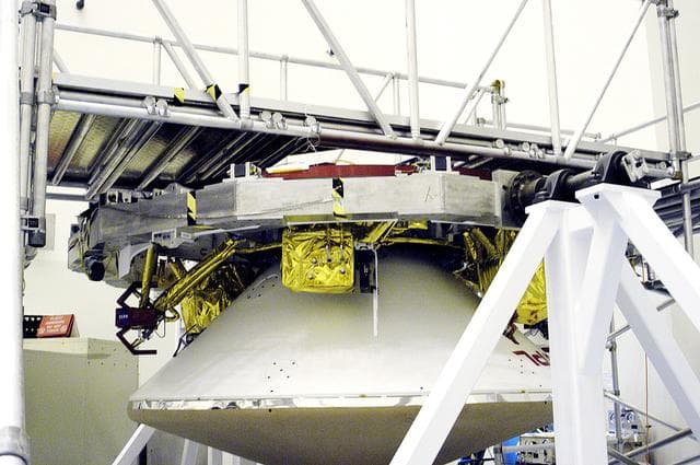 NASA image: KENNEDY SPACE CENTER, FLA. - In the  Payload Hazardous Servicing Facility, the cruise stage is mated to the Mars Exploration Rover 2 (MER-2) entry vehicle.    The cruise stage includes fuel tanks, thruster clusters and avionics for steering and propulsion.  NASA's twin Mars Exploration Rovers are designed to study the history of water on Mars. These robotic geologists are equipped with a robotic arm, a drilling tool, three spectrometers, and four pairs of cameras that allow them to have a human-like, 3D view of the terrain. Each rover could travel as far as 100 meters in one day to act as Mars scientists' eyes and hands, exploring an environment where humans can't yet go.  MER-2 is scheduled to launch June 5 as MER-A aboard a Delta rocket from Cape Canaveral Air Force Station.