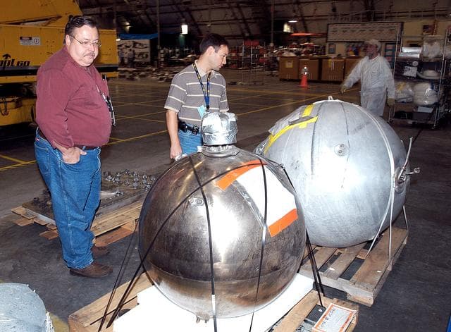 NASA image: KENNEDY SPACE CENTER, FLA. -  Members of the Columbia Reconstruction Project Team examine pieces of debris in the RLV Hangar. The items shipped to KSC number more than 82,000 and weigh 84,800 pounds or 38 percent of the total dry weight of Columbia. Of those items, 78,760 have been identified, with 753 placed on the left wing grid in the Hangar.
