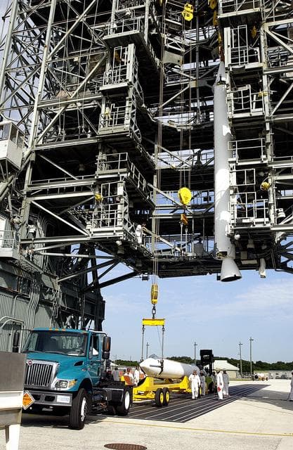 NASA image: KENNEDY SPACE CENTER, FLA. -  While one solid rocket booster (SRB) is suspended in the launch tower on Launch Complex 17-A, Cape Canaveral Air Force Station, another is raised from its transporter for a similar lift.  They are two of nine SRBs that will be mated to the Delta rocket to launch Mars Exploration Rover 2. NASA’s twin Mars Exploration Rovers are designed to study the history of water on Mars. These robotic geologists are equipped with a robotic arm, a drilling tool, three spectrometers, and four pairs of cameras that allow them to have a human-like, 3D view of the terrain. Each rover could travel as far as 100 meters in one day to act as Mars scientists' eyes and hands, exploring an environment where humans can’t yet go.  MER-2 is scheduled to launch June 5 as MER-A.  MER-1 (MER-B) will launch June 25.