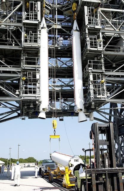 NASA image: KENNEDY SPACE CENTER, FLA. - While two solid rocket boosters (SRBs) are suspended in the launch tower on Launch Complex 17-A, Cape Canaveral Air Force Station, another is being raised from its transporter for a similar lift.  They are three of nine SRBs that will be mated to the Delta rocket to launch Mars Exploration Rover 2. NASA’s twin Mars Exploration Rovers are designed to study the history of water on Mars. These robotic geologists are equipped with a robotic arm, a drilling tool, three spectrometers, and four pairs of cameras that allow them to have a human-like, 3D view of the terrain. Each rover could travel as far as 100 meters in one day to act as Mars scientists' eyes and hands, exploring an environment where humans can’t yet go.  MER-2 is scheduled to launch June 5 as MER-A.  MER-1 (MER-B) will launch June 25.