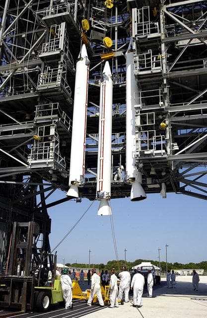 NASA image: KENNEDY SPACE CENTER, FLA. - A third solid rocket booster (SRB) joins the first two in the launch tower  on Launch Complex 17-A, Cape Canaveral Air Force Station.  They are three of nine SRBs that will be mated to the Delta rocket to launch Mars Exploration Rover 2. NASA’s twin Mars Exploration Rovers are designed to study the history of water on Mars. These robotic geologists are equipped with a robotic arm, a drilling tool, three spectrometers, and four pairs of cameras that allow them to have a human-like, 3D view of the terrain. Each rover could travel as far as 100 meters in one day to act as Mars scientists' eyes and hands, exploring an environment where humans can’t yet go.  MER-2 is scheduled to launch June 5 as MER-A.  MER-1 (MER-B) will launch June 25.