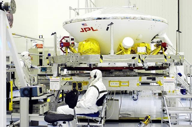 NASA image: KENNEDY SPACE CENTER, FLA. - The aeroshell, the entry vehicle for Mars Exploration Rover 1 (MER-1), is ready for integration with its cruise stage, seen here below the backshell.  What appears to be the top half of the aeroshell is the heat shield.  NASA’s twin Mars Exploration Rovers are designed to study the history of water on Mars. These robotic geologists are equipped with a robotic arm, a drilling tool, three spectrometers, and four pairs of cameras that allow them to have a human-like, 3D view of the terrain. Each rover could travel as far as 100 meters in one day to act as Mars scientists' eyes and hands, exploring an environment where humans can’t yet go.  The MER-1 is scheduled to launch June 25 from Launch Pad 17-A, Cape Canaveral Air Force Station.