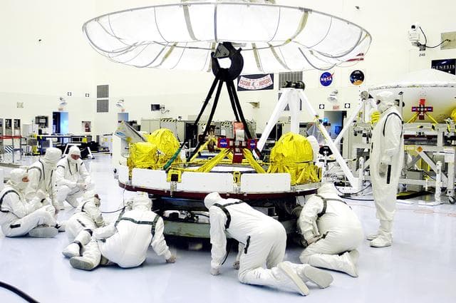 NASA image: KENNEDY SPACE CENTER, FLA. - Workers in the Payload Hazardous Servicing Facility check the cruise stage of Mars Exploration Rover 1 (MER-1) that will be lifted and moved by the overhead crane for integration with the aeroshell, the entry vehicle.  NASA’s twin Mars Exploration Rovers are designed to study the history of water on Mars. These robotic geologists are equipped with a robotic arm, a drilling tool, three spectrometers, and four pairs of cameras that allow them to have a human-like, 3D view of the terrain. Each rover could travel as far as 100 meters in one day to act as Mars scientists' eyes and hands, exploring an environment where humans can’t yet go.  The MER-1 is scheduled to launch June 25 from Launch Pad 17-A, Cape Canaveral Air Force Station.