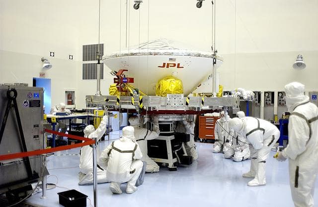 NASA image: KENNEDY SPACE CENTER, FLA. - In the Payload Hazardous Servicing Facility, workers secure the Mars Exploration Rover 2 (MER-2) on the spin table.  NASA’s twin Mars Exploration Rovers are designed to study the history of water on Mars. These robotic geologists are equipped with a robotic arm, a drilling tool, three spectrometers, and four pairs of cameras that allow them to have a human-like, 3D view of the terrain. Each rover could travel as far as 100 meters in one day to act as Mars scientists' eyes and hands, exploring an environment where humans can’t yet go.  The MER-2 is scheduled to launch June 5 from Launch Pad 17-A, Cape Canaveral Air Force Station.