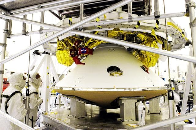 NASA image: KENNEDY SPACE CENTER, FLA. - The Mars Exploration Rover 1 (MER-1) lander  (below) is mated to the cruise stage, seen above the lander.  NASA's twin Mars Exploration Rovers are designed to study the history of water on Mars. These robotic geologists are equipped with a robotic arm, a drilling tool, three spectrometers, and four pairs of cameras that allow them to have a human-like, 3D view of the terrain. Each rover could travel as far as 100 meters in one day to act as Mars scientists' eyes and hands, exploring an environment where humans can't yet go.  MER-1 is scheduled to launch June 25 as MER-B aboard a Delta II rocket from Cape Canaveral Air Force Station.