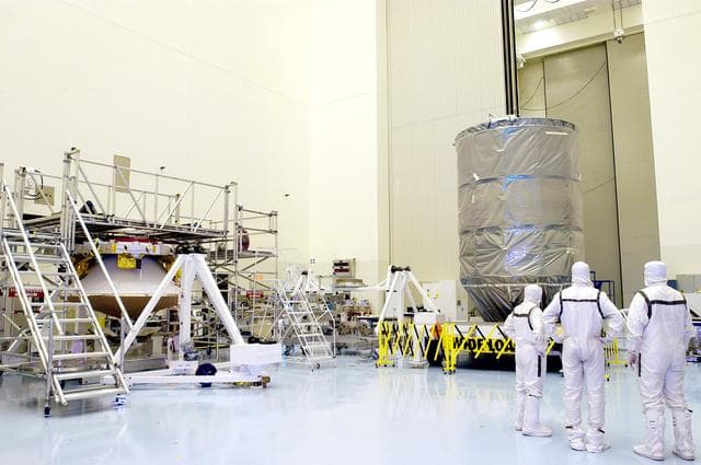 NASA image: KENNEDY SPACE CENTER, FLA. - The Delta II rocket’s third stage waits in the Payload Hazardous Servicing Facility for mating with the Mars Exploration Rover 2 (MER-2).  They will then be installed into the transportation canister for transfer to the launch pad.  NASA's twin Mars Exploration Rovers are designed to study the history of water on Mars. These robotic geologists are equipped with a robotic arm, a drilling tool, three spectrometers, and four pairs of cameras that allow them to have a human-like, 3D view of the terrain. Each rover could travel as far as 100 meters in one day to act as Mars scientists' eyes and hands, exploring an environment where humans can't yet go.  MER-2 is scheduled to launch June 5 as MER-A aboard a Delta II rocket from Cape Canaveral Air Force Station.