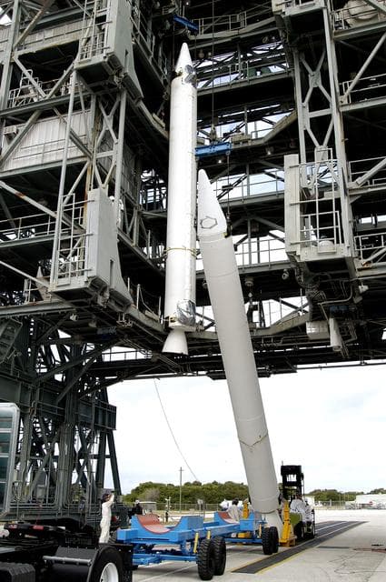 NASA image: KENNEDY SPACE CENTER, FLA. - Another solid rocket booster is raised to vertical on Launch Complex 17-B, Cape Canaveral Air Force Station.  It is the second of nine SRBs that will be mated to the Delta II rocket for the Mars Exploration Rover 1 (MER-1) launch June 25.  NASA’s twin Mars Exploration Rovers are designed to study the history of water on Mars. These robotic geologists are equipped with a robotic arm, a drilling tool, three spectrometers, and four pairs of cameras that allow them to have a human-like, 3D view of the terrain. Each rover could travel as far as 100 meters in one day to act as Mars scientists' eyes and hands, exploring an environment where humans can’t yet go.  MER-2 (MER-A) will launch June 5.