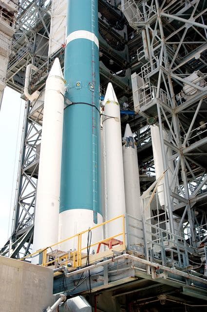 NASA image: KENNEDY SPACE CENTER, FLA. - On the launch tower of Launch Complex 17-B, Cape Canaveral Air Force Station, solid rocket boosters are mated to the Delta II rocket for the Mars Exploration Rover 1 (MER-1) launch June 25.  NASA’s twin Mars Exploration Rovers are designed to study the history of water on Mars. These robotic geologists are equipped with a robotic arm, a drilling tool, three spectrometers, and four pairs of cameras that allow them to have a human-like, 3D view of the terrain. Each rover could travel as far as 100 meters in one day to act as Mars scientists' eyes and hands, exploring an environment where humans can’t yet go.  MER-2 (MER-A) will launch June 5.