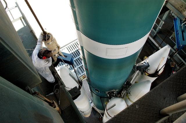 NASA image: KENNEDY SPACE CENTER, FLA. - On the launch tower of Launch Complex 17-B, Cape Canaveral Air Force Station, solid rocket boosters are mated to the Delta II rocket for the Mars Exploration Rover 1 (MER-1) launch June 25.  NASA’s twin Mars Exploration Rovers are designed to study the history of water on Mars. These robotic geologists are equipped with a robotic arm, a drilling tool, three spectrometers, and four pairs of cameras that allow them to have a human-like, 3D view of the terrain. Each rover could travel as far as 100 meters in one day to act as Mars scientists' eyes and hands, exploring an environment where humans can’t yet go.  MER-2 (MER-A) will launch June 5.