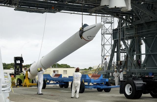 NASA image: KENNEDY SPACE CENTER, FLA. -  On Launch Complex 17-B, Cape Canaveral Air Force Station, a solid rocket booster is raised off  its transporter to lift it to vertical.  It will be mated to the Delta II rocket for the Mars Exploration Rover 1 (MER-1) launch June 25.  NASA’s twin Mars Exploration Rovers are designed to study the history of water on Mars. These robotic geologists are equipped with a robotic arm, a drilling tool, three spectrometers, and four pairs of cameras that allow them to have a human-like, 3D view of the terrain. Each rover could travel as far as 100 meters in one day to act as Mars scientists' eyes and hands, exploring an environment where humans can’t yet go.  MER-2 (MER-A) will launch June 5.