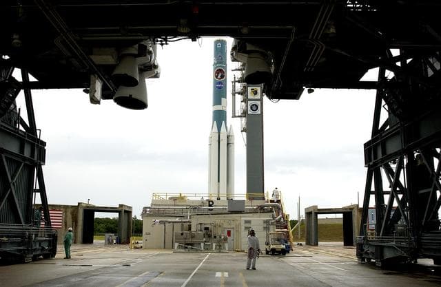 NASA image: KENNEDY SPACE CENTER, FLA. -  Solid rocket boosters are positioned around the base of a Delta II rocket for the Mars Exploration Rover 1 (MER-1) launch on June 25 at Launch Complex 17-B, Cape Canaveral Air Force Station.  NASA’s twin Mars Exploration Rovers are designed to study the history of water on Mars. These robotic geologists are equipped with a robotic arm, a drilling tool, three spectrometers, and four pairs of cameras that allow them to have a human-like, 3D view of the terrain. Each rover could travel as far as 100 meters in one day to act as Mars scientists' eyes and hands, exploring an environment where humans can’t yet go.  MER-2 (MER-A) will launch June 5.
