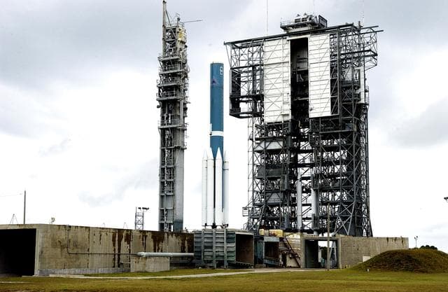 NASA image: KENNEDY SPACE CENTER, FLA. -  Solid rocket boosters are positioned around the base of a Delta II rocket for the Mars Exploration Rover 1 (MER-1) launch on June 25 at Launch Complex 17-B, Cape Canaveral Air Force Station.  NASA’s twin Mars Exploration Rovers are designed to study the history of water on Mars. These robotic geologists are equipped with a robotic arm, a drilling tool, three spectrometers, and four pairs of cameras that allow them to have a human-like, 3D view of the terrain. Each rover could travel as far as 100 meters in one day to act as Mars scientists' eyes and hands, exploring an environment where humans can’t yet go.  MER-2 (MER-A) will launch June 5.