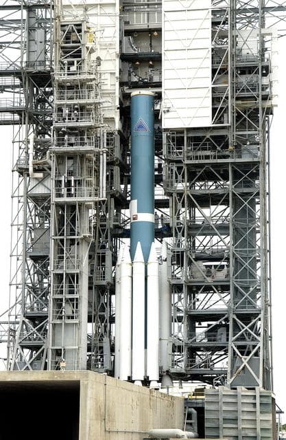 NASA image: KENNEDY SPACE CENTER, FLA. -  Solid rocket boosters are attached to the base of a Delta II rocket for the Mars Exploration Rover 1 (MER-1) launch on June 25 at Launch Complex 17-B, Cape Canaveral Air Force Station.  NASA’s twin Mars Exploration Rovers are designed to study the history of water on Mars. These robotic geologists are equipped with a robotic arm, a drilling tool, three spectrometers, and four pairs of cameras that allow them to have a human-like, 3D view of the terrain. Each rover could travel as far as 100 meters in one day to act as Mars scientists' eyes and hands, exploring an environment where humans can’t yet go.  MER-2 (MER-A) will launch June 5.