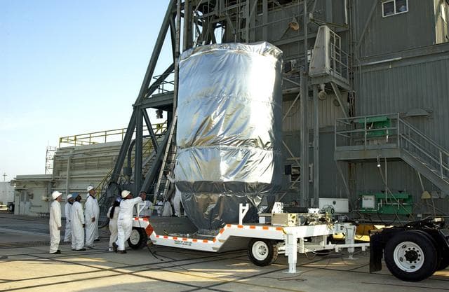 NASA image: KENNEDY SPACE CENTER, FLA. - The Mars Exploration Rover 2 (MER-2), inside the transport canister, will be lifted up the launch tower on Launch Pad 17-A, Cape Canaveral Air Force Station, where it will be mated to the Delta II rocket for launch.  MER-2 is one of NASA's twin Mars Exploration Rovers designed to study the history of water on Mars. These robotic geologists are equipped with a robotic arm, a drilling tool, three spectrometers, and four pairs of cameras that allow them to have a human-like, 3D view of the terrain. Each rover could travel as far as 100 meters in one day to act as Mars scientists' eyes and hands, exploring an environment where humans can't yet go.  MER-2 is scheduled to launch no earlier than June 8 as MER-A.