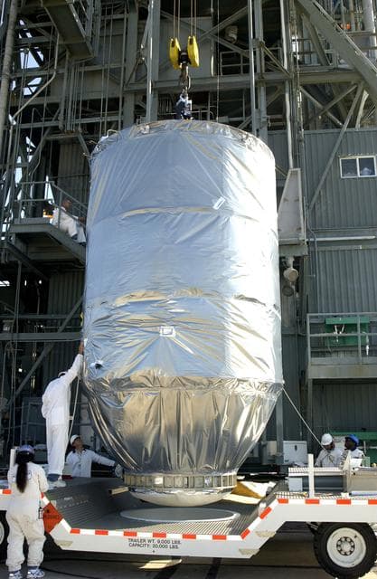 NASA image: KENNEDY SPACE CENTER, FLA. - On Launch Pad 17-A, Cape Canaveral Air Force Station, the Mars Exploration Rover 2 (MER-2), inside the transport canister, is ready to be lifted into the launch tower where it will be mated to the Delta II rocket for launch.  MER-2 is one of NASA's twin Mars Exploration Rovers designed to study the history of water on Mars. These robotic geologists are equipped with a robotic arm, a drilling tool, three spectrometers, and four pairs of cameras that allow them to have a human-like, 3D view of the terrain. Each rover could travel as far as 100 meters in one day to act as Mars scientists' eyes and hands, exploring an environment where humans can't yet go.  MER-2 is scheduled to launch no earlier than June 8 as MER-A.