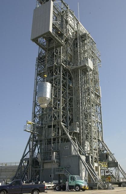 NASA image: KENNEDY SPACE CENTER, FLA. - On Launch Pad 17-A, Cape Canaveral Air Force Station, the Mars Exploration Rover 2 (MER-2), inside the transport canister, is lifted up the launch tower where it will be mated to the Delta II rocket for launch.  MER-2 is one of NASA's twin Mars Exploration Rovers designed to study the history of water on Mars. These robotic geologists are equipped with a robotic arm, a drilling tool, three spectrometers, and four pairs of cameras that allow them to have a human-like, 3D view of the terrain. Each rover could travel as far as 100 meters in one day to act as Mars scientists' eyes and hands, exploring an environment where humans can't yet go.  MER-2 is scheduled to launch no earlier than June 8 as MER-A.