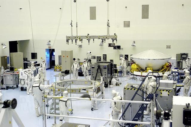 NASA image: KENNEDY SPACE CENTER, FLA. - In the Payload Hazardous Servicing Facility, the Mars Exploration Rover-1 (MER-B) awaits further preflight processing atop a spin table.  The rover is scheduled to launch aboard a Delta II rocket on June 25.  NASA’s twin Mars Exploration Rovers are designed to study the history of water on Mars. These robotic geologists are equipped with a robotic arm, a drilling tool, three spectrometers, and four pairs of cameras that allow them to have a human-like, 3D view of the terrain. Each rover could travel as far as 100 meters in one day to act as Mars scientists' eyes and hands, exploring an environment where humans are not yet able to go. The launch of MER-2 (MER-A) is tentatively set for June 8.