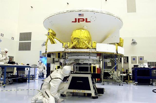 NASA image: KENNEDY SPACE CENTER, FLA. - In the Payload Hazardous Servicing Facility, workers secure the Mars Exploration Rover-1 (MER-B) to a spin table during preflight processing of the spacecraft. The rover is scheduled to launch aboard a Delta II rocket on June 25. NASA’s twin Mars Exploration Rovers are designed to study the history of water on Mars. These robotic geologists are equipped with a robotic arm, a drilling tool, three spectrometers, and four pairs of cameras that allow them to have a human-like, 3D view of the terrain. Each rover could travel as far as 100 meters in one day to act as Mars scientists' eyes and hands, exploring an environment where humans are not yet able to go. The launch of MER-2 (MER-A) is tentatively set for June 8.