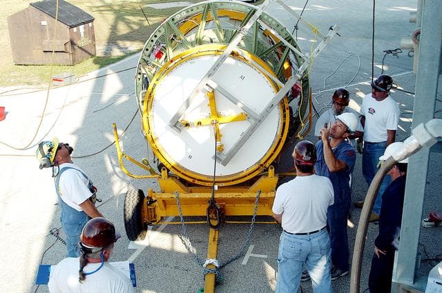 NASA image: KENNEDY SPACE CENTER, FLA. - The second stage of a Delta II rocket is prepared for lifting up the launch tower on Pad 17-B, Cape Canaveral Air Force Station.  It will be mated to the Delta first stage already at the pad in preparation for the launch of the Mars Exploration Rover-1 (MER-B) on June 25.  NASA’s twin Mars Exploration Rovers are designed to study the history of water on Mars. These robotic geologists are equipped with a robotic arm, a drilling tool, three spectrometers, and four pairs of cameras that allow them to have a human-like, 3D view of the terrain. Each rover could travel as far as 100 meters in one day to act as Mars scientists' eyes and hands, exploring an environment where humans are not yet able to go. The launch of MER-2 (MER-A) is tentatively set for June 8.