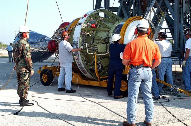 NASA image: KENNEDY SPACE CENTER, FLA. - Workers prepare to lift the second stage of a Delta II rocket up the launch tower on Pad 17-B, Cape Canaveral Air Force Station.  It will be mated to the Delta first stage already at the pad in preparation for the launch of the Mars Exploration Rover-1 (MER-B) on June 25.  NASA’s twin Mars Exploration Rovers are designed to study the history of water on Mars. These robotic geologists are equipped with a robotic arm, a drilling tool, three spectrometers, and four pairs of cameras that allow them to have a human-like, 3D view of the terrain. Each rover could travel as far as 100 meters in one day to act as Mars scientists' eyes and hands, exploring an environment where humans are not yet able to go. The launch of MER-2 (MER-A) is tentatively set for June 8.