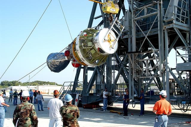 NASA image: KENNEDY SPACE CENTER, FLA. - Workers begin to lift the second stage of a Delta II rocket up the launch tower on Pad 17-B, Cape Canaveral Air Force Station.  It will be mated to the Delta first stage already at the pad in preparation for the launch of the Mars Exploration Rover-1 (MER-B) on June 25.  NASA’s twin Mars Exploration Rovers are designed to study the history of water on Mars. These robotic geologists are equipped with a robotic arm, a drilling tool, three spectrometers, and four pairs of cameras that allow them to have a human-like, 3D view of the terrain. Each rover could travel as far as 100 meters in one day to act as Mars scientists' eyes and hands, exploring an environment where humans are not yet able to go. The launch of MER-2 (MER-A) is tentatively set for June 8.