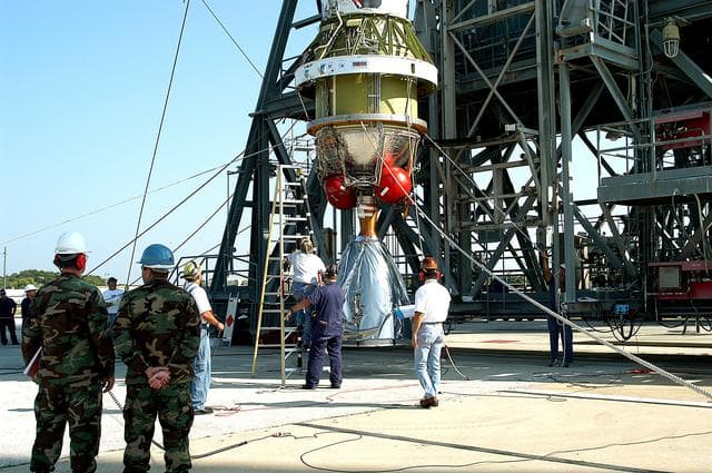 NASA image: KENNEDY SPACE CENTER, FLA. - The second stage of a Delta II rocket is raised to a vertical position for its lift up the launch tower on Pad 17-B, Cape Canaveral Air Force Station.  It will be mated to the Delta first stage already at the pad in preparation for the launch of the Mars Exploration Rover-1 (MER-B) on June 25.  NASA’s twin Mars Exploration Rovers are designed to study the history of water on Mars. These robotic geologists are equipped with a robotic arm, a drilling tool, three spectrometers, and four pairs of cameras that allow them to have a human-like, 3D view of the terrain. Each rover could travel as far as 100 meters in one day to act as Mars scientists' eyes and hands, exploring an environment where humans are not yet able to go. The launch of MER-2 (MER-A) is tentatively set for June 8.
