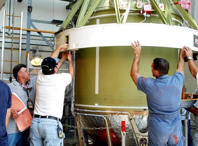NASA image: KENNEDY SPACE CENTER, FLA. - The second stage of a Delta II rocket is lowered into positioned above a first stage at Pad 17-B, Cape Canaveral Air Force Station. Next, it will be mated to the first stage in preparation for the launch of the Mars Exploration Rover-1 (MER-B) on June 25.  NASA’s twin Mars Exploration Rovers are designed to study the history of water on Mars. These robotic geologists are equipped with a robotic arm, a drilling tool, three spectrometers, and four pairs of cameras that allow them to have a human-like, 3D view of the terrain. Each rover could travel as far as 100 meters in one day to act as Mars scientists' eyes and hands, exploring an environment where humans are not yet able to go. The launch of MER-2 (MER-A) is tentatively set for June 8.