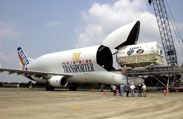 NASA image: KENNEDY SPACE CENTER, FLA. - The Italian-built module, U.S. Node 2, for the International Space Station is offloaded from a Beluga aircraft at the Shuttle Landing Facility. The second of three Station connecting modules, Node 2 attaches to the end of the U.S. Lab and provides attach locations for the Japanese laboratory, European laboratory, the Centrifuge Accommodation Module and, later, Multipurpose Logistics Modules. It will provide the primary docking location for the Shuttle when a pressurized mating adapter is attached to Node 2.  Installation of the module will complete  the U.S. Core of the ISS.  Node 2 is the designated payload for mission STS-120.  No orbiter or launch date has been determined yet.