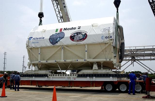 NASA image: KENNEDY SPACE CENTER, FLA. -  The Italian-built module, U.S. Node 2, is lowered onto a transporter after its arrival at the Shuttle Landing Facility.  It will be taken to the Space Station Processing Facility.  The second of three connecting modules on the International Space Station, Node 2 attaches to the end of the U.S. Lab and provides attach locations for the Japanese laboratory, European laboratory, the Centrifuge Accommodation Module and, later, Multipurpose Logistics Modules. It will provide the primary docking location for the Shuttle when a pressurized mating adapter is attached to Node 2.  Installation of the module will complete  the U.S. Core of the ISS.  Node 2 is the designated payload for mission STS-120.  No orbiter or launch date has been determined yet.