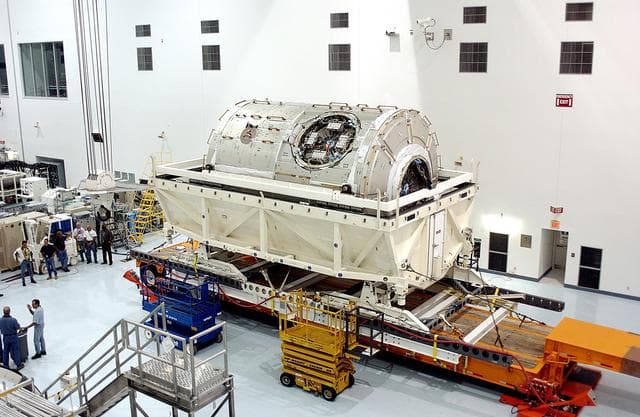 NASA image: KENNEDY SPACE CENTER, FLA. - The U.S. Node 2 is unveiled after its arrival in the Space Station Processing Facility.  The second of three Station connecting modules, the Italian-built Node 2 attaches to the end of the U.S. Lab and provides attach locations for the Japanese laboratory, European laboratory, the Centrifuge Accommodation Module and, later, Multipurpose Logistics Modules. It will provide the primary docking location for the Shuttle when a pressurized mating adapter is attached to Node 2.  Installation of the module will complete  the U.S. Core of the ISS.  Node 2 is the designated payload for mission STS-120.  No orbiter or launch date has been determined yet.