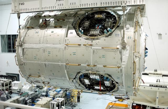 NASA image: KENNEDY SPACE CENTER, FLA. - An overhead crane in the Space Station Processing Facility moves the U.S. Node 2 across the floor to a workstand.  The second of three connecting modules on the International Space Station, the Italian-built Node 2 attaches to the end of the U.S. Lab and provides attach locations for the Japanese laboratory, European laboratory, the Centrifuge Accommodation Module and, later, Multipurpose Logistics Modules. It will provide the primary docking location for the Shuttle when a pressurized mating adapter is attached to Node 2.  Installation of the module will complete  the U.S. Core of the ISS.  Node 2 is the designated payload for mission STS-120.  No orbiter or launch date has been determined yet.