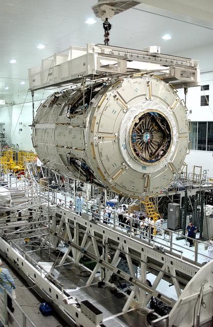 NASA image: KENNEDY SPACE CENTER, FLA. - The U.S. Node 2 moves toward a workstand in the Space Station Processing Facility.  The second of three connecting modules on the International Space Station, the Italian-built Node 2 attaches to the end of the U.S. Lab and provides attach locations for the Japanese laboratory, European laboratory, the Centrifuge Accommodation Module and, later, Multipurpose Logistics Modules. It will provide the primary docking location for the Shuttle when a pressurized mating adapter is attached to Node 2.  Installation of the module will complete  the U.S. Core of the ISS.  Node 2 is the designated payload for mission STS-120.  No orbiter or launch date has been determined yet.