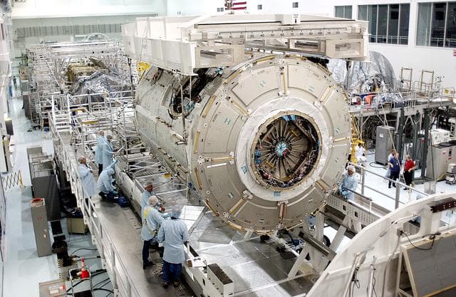 NASA image: KENNEDY SPACE CENTER, FLA. - The U.S. Node 2 is lowered toward a workstand in the Space Station Processing Facility.  The second of three connecting modules on the International Space Station, the Italian-built Node 2 attaches to the end of the U.S. Lab and provides attach locations for the Japanese laboratory, European laboratory, the Centrifuge Accommodation Module and, later, Multipurpose Logistics Modules. It will provide the primary docking location for the Shuttle when a pressurized mating adapter is attached to Node 2.  Installation of the module will complete  the U.S. Core of the ISS.  Node 2 is the designated payload for mission STS-120.  No orbiter or launch date has been determined yet.