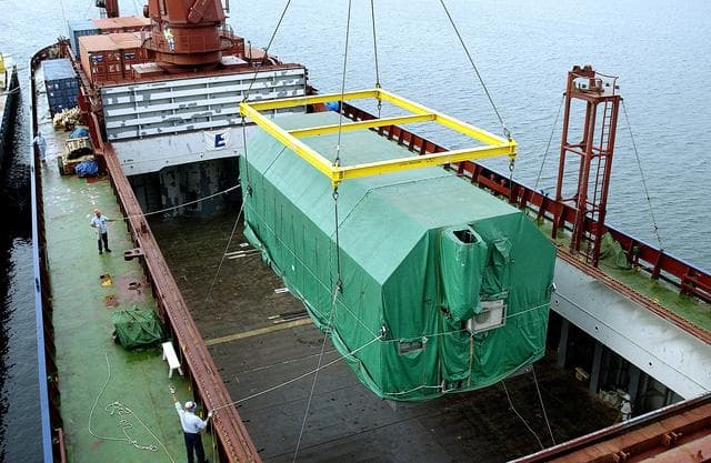 NASA image: KENNEDY SPACE CENTER, FLA. - At Port Canaveral, the Pressurized Module of the Japanese Experiment Module (JEM) is lifted out of the ship’s cargo hold.  The container transport ship carrying JEM departed May 2 from Yokohama Harbor in Japan for the voyage to the United States. The National Space Development Agency of Japan (NASDA) developed the laboratory at the Tsukuba Space Center near Tokyo. The Pressurized Module is the first element of the JEM, named "Kibo" (Hope), to be delivered to KSC. The JEM is Japan's primary contribution to the Station. It will enhance the unique research capabilities of the orbiting complex by providing an additional environment for astronauts to conduct science experiments.  The JEM also includes an exposed facility (platform) for space environment experiments, a robotic manipulator system, and two logistics modules. The various JEM components will be  assembled in space over the course of three Shuttle missions.