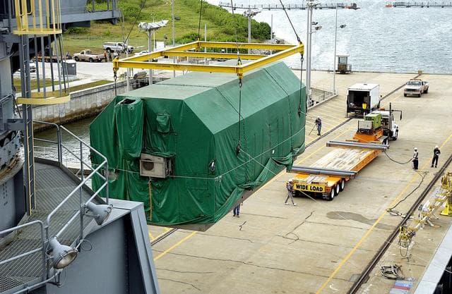 NASA image: KENNEDY SPACE CENTER, FLA. - At Port Canaveral, the Pressurized Module of the Japanese Experiment Module (JEM) is lifted out of the ship’s cargo hold.  It will be loaded onto the truck bed in the background for transfer to KSC’s Space Station Processing Facility.  The container transport ship carrying JEM departed May 2 from Yokohama Harbor in Japan for the voyage to the United States. The National Space Development Agency of Japan (NASDA) developed the laboratory at the Tsukuba Space Center near Tokyo. The Pressurized Module is the first element of the JEM, named "Kibo" (Hope), to be delivered to KSC. The JEM is Japan's primary contribution to the Station. It will enhance the unique research capabilities of the orbiting complex by providing an additional environment for astronauts to conduct science experiments.  The JEM also includes an exposed facility (platform) for space environment experiments, a robotic manipulator system, and two logistics modules. The various JEM components will be  assembled in space over the course of three Shuttle missions.