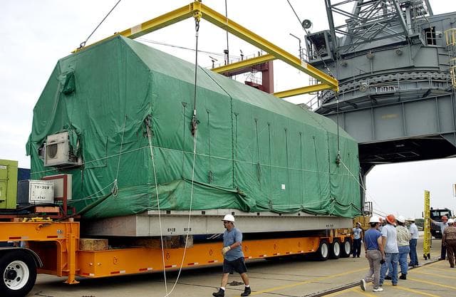 NASA image: KENNEDY SPACE CENTER, FLA. - At Port Canaveral, the overhead crane that lifted the Pressurized Module of the Japanese Experiment Module (JEM) from the ship onto the truck bed is released.  The container transport ship carrying JEM departed May 2 from Yokohama Harbor in Japan for the voyage to the United States. The National Space Development Agency of Japan (NASDA) developed the laboratory at the Tsukuba Space Center near Tokyo. The Pressurized Module is the first element of the JEM, named "Kibo" (Hope), to be delivered to KSC, and will be transferred to KSC’s Space Station Processing Facility.  The JEM is Japan's primary contribution to the Station. It will enhance the unique research capabilities of the orbiting complex by providing an additional environment for astronauts to conduct science experiments.  The JEM also includes an exposed facility (platform) for space environment experiments, a robotic manipulator system, and two logistics modules. The various JEM components will be  assembled in space over the course of three Shuttle missions.