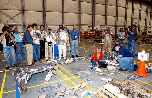 NASA image: KENNEDY SPACE CENTER, FLA. - The media get a guided tour of the Columbia Debris Hangar.  Shuttle Launch Director Mike Leinbach discussed activities that have taken place since the Columbia accident on Feb. 1, 2003.  STS-107 debris recovery and reconstruction operations are winding down.  To date, nearly 84,000 pieces of debris have been recovered and sent to KSC. That represents about 38 percent of the dry weight of Columbia, equaling almost 85,000 pounds.