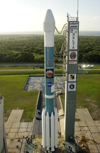 NASA image: KENNEDY SPACE CENTER, FLA. -  The Mobile Service Tower is rolled back at Launch Complex 17A to reveal a Delta II rocket ready to launch the Mars Exploration Rover-A mission.  NASA's twin Mars Exploration Rovers are designed to study the history of water on Mars. These robotic geologists are equipped with a robotic arm, a drilling tool, three spectrometers, and four pairs of cameras that allow them to have a human-like, 3D view of the terrain. Each rover could travel as far as 100 meters in one day to act as Mars scientists' eyes and hands, exploring an environment where humans are not yet able to go. MER-A, with the rover Spirit aboard, is scheduled to launch on June 8 at 2:06 p.m. EDT, with two launch opportunities each day during a launch period that closes on June 24.