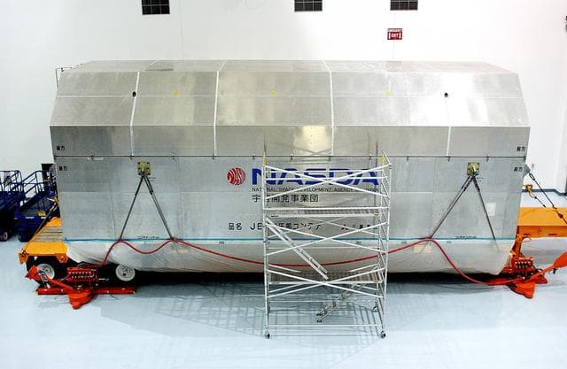 KENNEDY SPACE CENTER, FLA. - The container with the Japanese Experiment Module (JEM)’s pressurized module is inside the Space Station Processing Facility.  The National Space Development Agency of Japan (NASDA) developed the laboratory at the Tsukuba Space Center near Tokyo. The Pressurized Module is the first element of the JEM, named "Kibo" (Hope), to be delivered to KSC. The JEM is Japan's primary contribution to the Station. It will enhance the unique research capabilities of the orbiting complex by providing an additional environment for astronauts to conduct science experiments.  The JEM also includes an exposed facility (platform) for space environment experiments, a robotic manipulator system, and two logistics modules. The various JEM components will be  assembled in space over the course of three Shuttle missions.