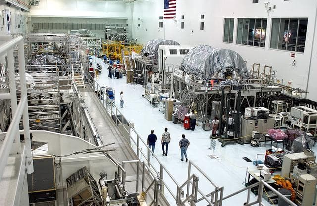NASA image: KENNEDY SPACE CENTER, FLA. - An overview of the Space Station Processing Facility shows workstands and ISS elements.   The most recent additions are the Japanese Experiment Module (JEM)’s pressurized module and the Italian-built Node 2.  The pressurized module is the first element of the JEM, Japan’s primary contribution to the Space Station, to be delivered to KSC. It will enhance the unique research capabilities of the orbiting complex by providing an additional shirt-sleeve environment for astronauts to conduct science experiments.  Node 2 will be installed on the end of the U.S. Lab and provides attach locations for the Japanese laboratory, European laboratory, the Centrifuge Accommodation Module and, later, Multipurpose Logistics Modules. It will provide the primary docking location for the Shuttle when a pressurized mating adapter is attached to Node 2.  Installation of the module will complete  the U.S. Core of the ISS.