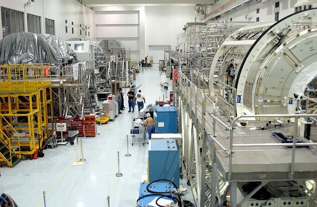 NASA image: KENNEDY SPACE CENTER, FLA. - A view of the Space Station Processing Facility shows workstands and ISS elements.   The most recent additions are the Japanese Experiment Module (JEM)’s pressurized module and the Italian-built Node 2.  The pressurized module is the first element of the JEM, Japan’s primary contribution to the Space Station, to be delivered to KSC. It will enhance the unique research capabilities of the orbiting complex by providing an additional shirt-sleeve environment for astronauts to conduct science experiments.  Node 2 will be installed on the end of the U.S. Lab and provides attach locations for the Japanese laboratory, European laboratory, the Centrifuge Accommodation Module and, later, Multipurpose Logistics Modules. It will provide the primary docking location for the Shuttle when a pressurized mating adapter is attached to Node 2.  Installation of the module will complete  the U.S. Core of the ISS.