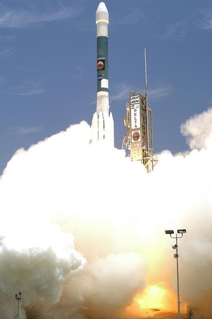 NASA image: KENNEDY SPACE CENTER, FLA. - Leaving smoke and steam behind, the Delta II rocket with its Mars Exploration Rover (MER-A) payload lifts off the pad on time at 1:58 p.m. EDT from Launch Complex 17-A, Cape Canaveral Air Force Station. MER-A, known as "Spirit," is the first of two rovers being launched to Mars. When the two rovers arrive at the red planet in 2004, they will bounce to airbag-cushioned landings at sites offering a balance of favorable conditions for safe landings and interesting science. The rovers see sharper images, can explore farther and examine rocks better than anything that has ever landed on Mars. The designated site for the MER-A mission is Gusev Crater, which appears to have been a crater lake. The second rover, MER-B, is scheduled to launch June 25.
