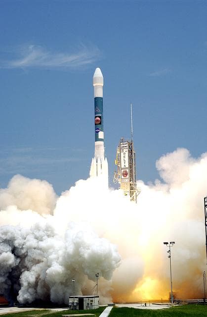 NASA image: KENNEDY SPACE CENTER, FLA. -  With smoke and steam billowing beneath, the Delta II rocket with its Mars Exploration Rover (MER-A) payload leaps off the launch pad into the blue sky to begin its journey to Mars.  Liftoff occurred on time at 1:58 p.m. EDT from Launch Complex 17-A, Cape Canaveral Air Force Station.  MER-A, known as "Spirit," is the first of two rovers being launched to Mars. When the two rovers arrive at the red planet in 2004, they will bounce to airbag-cushioned landings at sites offering a balance of favorable conditions for safe landings and interesting science. The rovers see sharper images, can explore farther and examine rocks better than anything that has ever landed on Mars. The designated site for the MER-A mission is Gusev Crater, which appears to have been a crater lake. The second rover, MER-B, is scheduled to launch June 25.