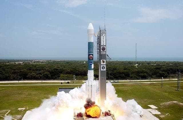 NASA image: KENNEDY SPACE CENTER, FLA. -  With a glimpse of the Atlantic Ocean over the horizon, the Delta II rocket with its Mars Exploration Rover (MER-A) payload leaps off the launch pad into the blue sky to begin its journey to Mars.  Liftoff occurred on time at 1:58 p.m. EDT from Launch Complex 17-A, Cape Canaveral Air Force Station.  MER-A, known as "Spirit," is the first of two rovers being launched to Mars. When the two rovers arrive at the red planet in 2004, they will bounce to airbag-cushioned landings at sites offering a balance of favorable conditions for safe landings and interesting science. The rovers see sharper images, can explore farther and examine rocks better than anything that has ever landed on Mars. The designated site for the MER-A mission is Gusev Crater, which appears to have been a crater lake. The second rover, MER-B, is scheduled to launch June 25.