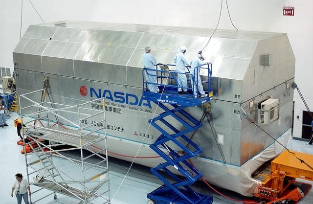 NASA image: KENNEDY SPACE CENTER, FLA. -   Workers in the Space Station Processing Facility prepare to remove the lid of the container with the Japanese Experiment Module (JEM) pressure module inside. A research laboratory, the pressurized module is the first element of the JEM, named "Kibo" (Hope), to be delivered to KSC.   The National Space Development Agency of Japan (NASDA) developed the laboratory at the Tsukuba Space Center near Tokyo and is Japan's primary contribution to the Station. It will enhance the unique research capabilities of the orbiting complex by providing an additional environment for astronauts to conduct science experiments.  The JEM also includes an exposed facility (platform) for space environment experiments, a robotic manipulator system, and two logistics modules. The various JEM components will be  assembled in space over the course of three Shuttle missions.